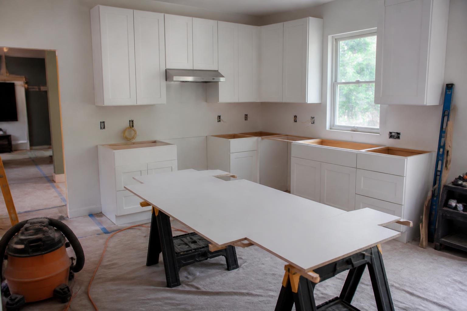 Remodeled American kitchen with white shaker cabinets, quartz island, hardwood floors, and stainless steel appliances